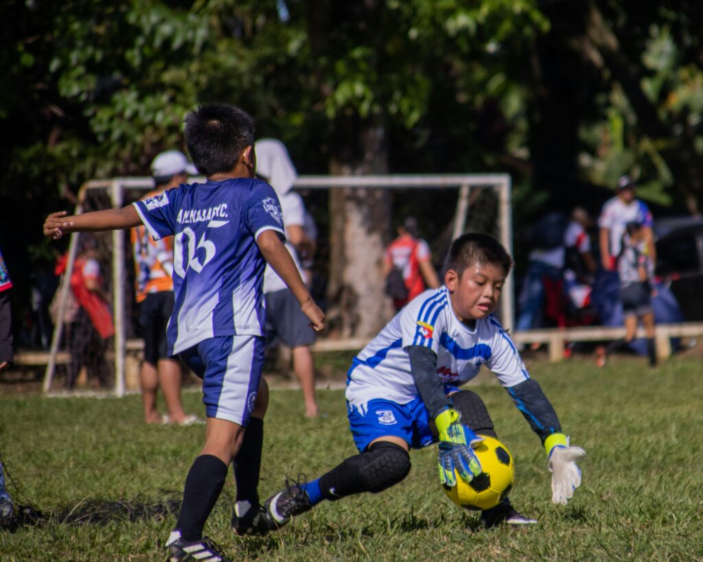 Young goalkeeper reacting to ball